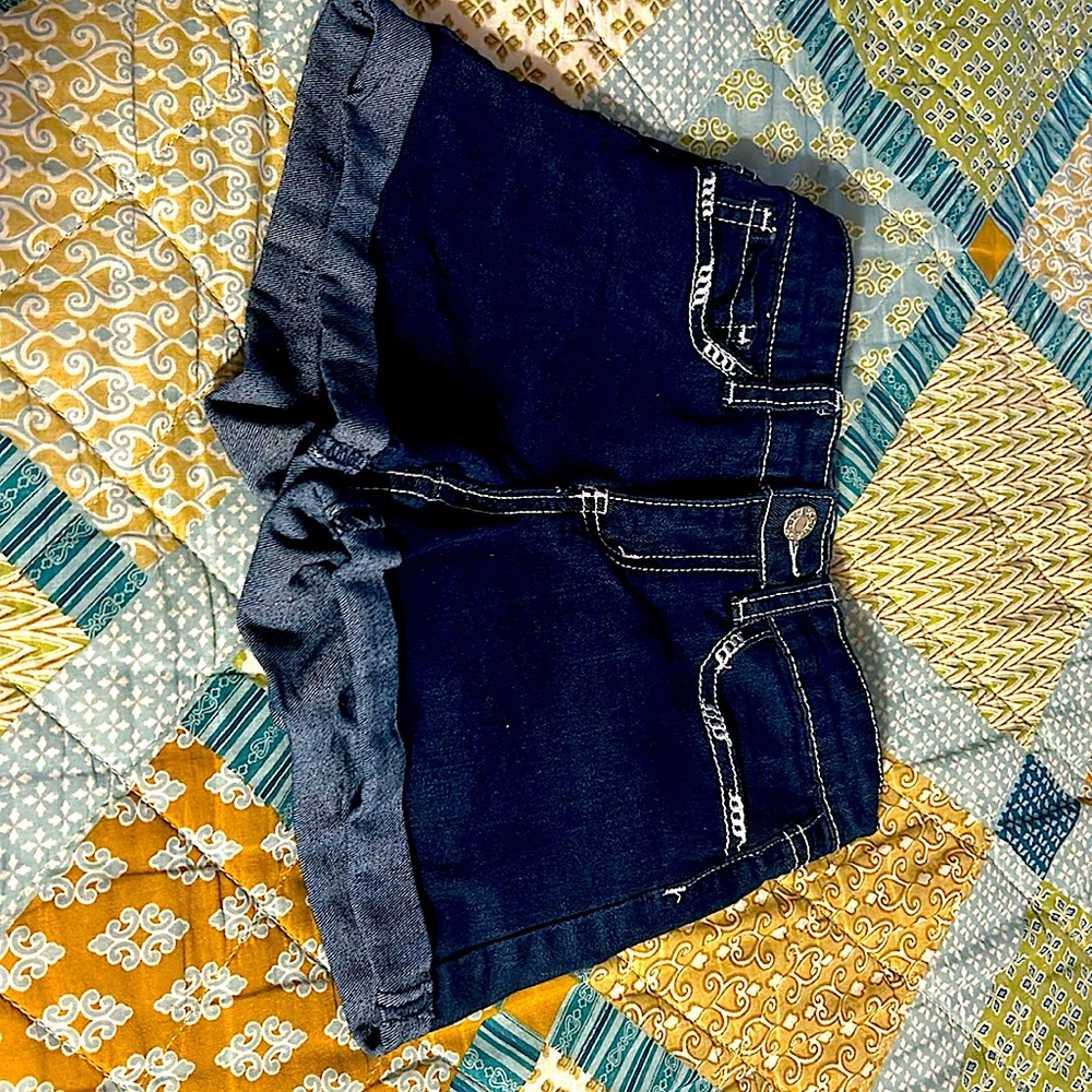 Size 8 girls , blue jean shorts, design on back pockets